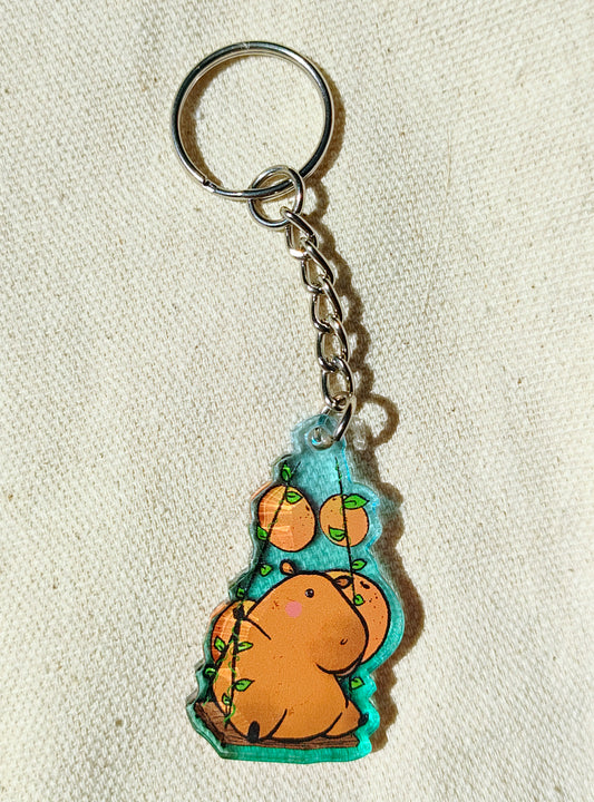 Capybara on a swing acrylic keychain