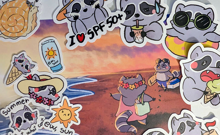 A sheet of die-cut stickers featuring cute cartoon raccoons in beach and summer-themed poses, including sunglasses, a straw hat, sunscreen bottle, sun, and beach scenes, arranged on a white background.